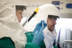 Researchers in safety gear conducting tests