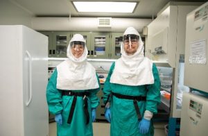 Researchers wearing laboratory safety gear