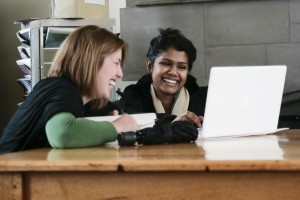 Two women working with a laptop